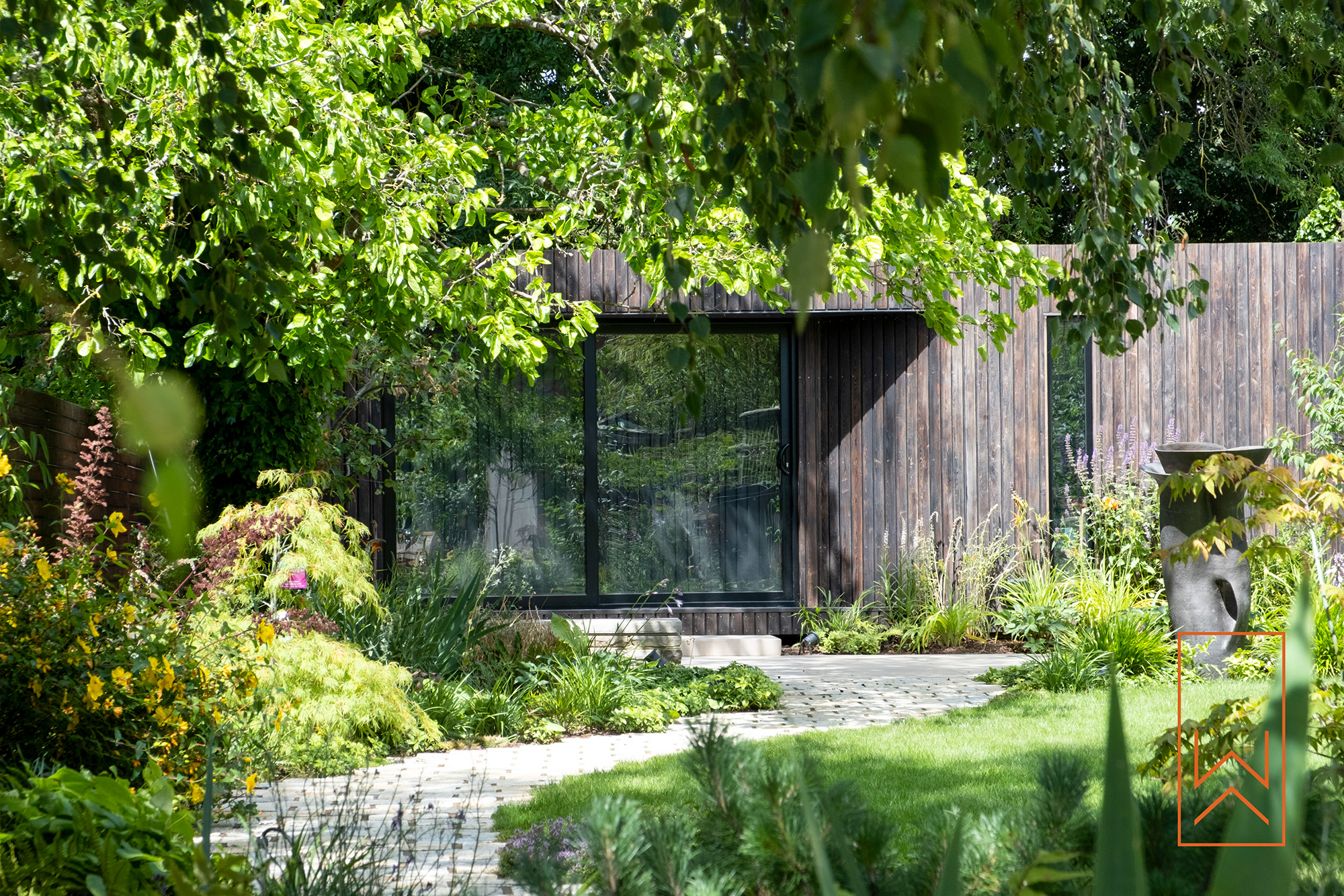 Bespoke garden studio surrounded by planting in modern town garden, Leamington Spa.