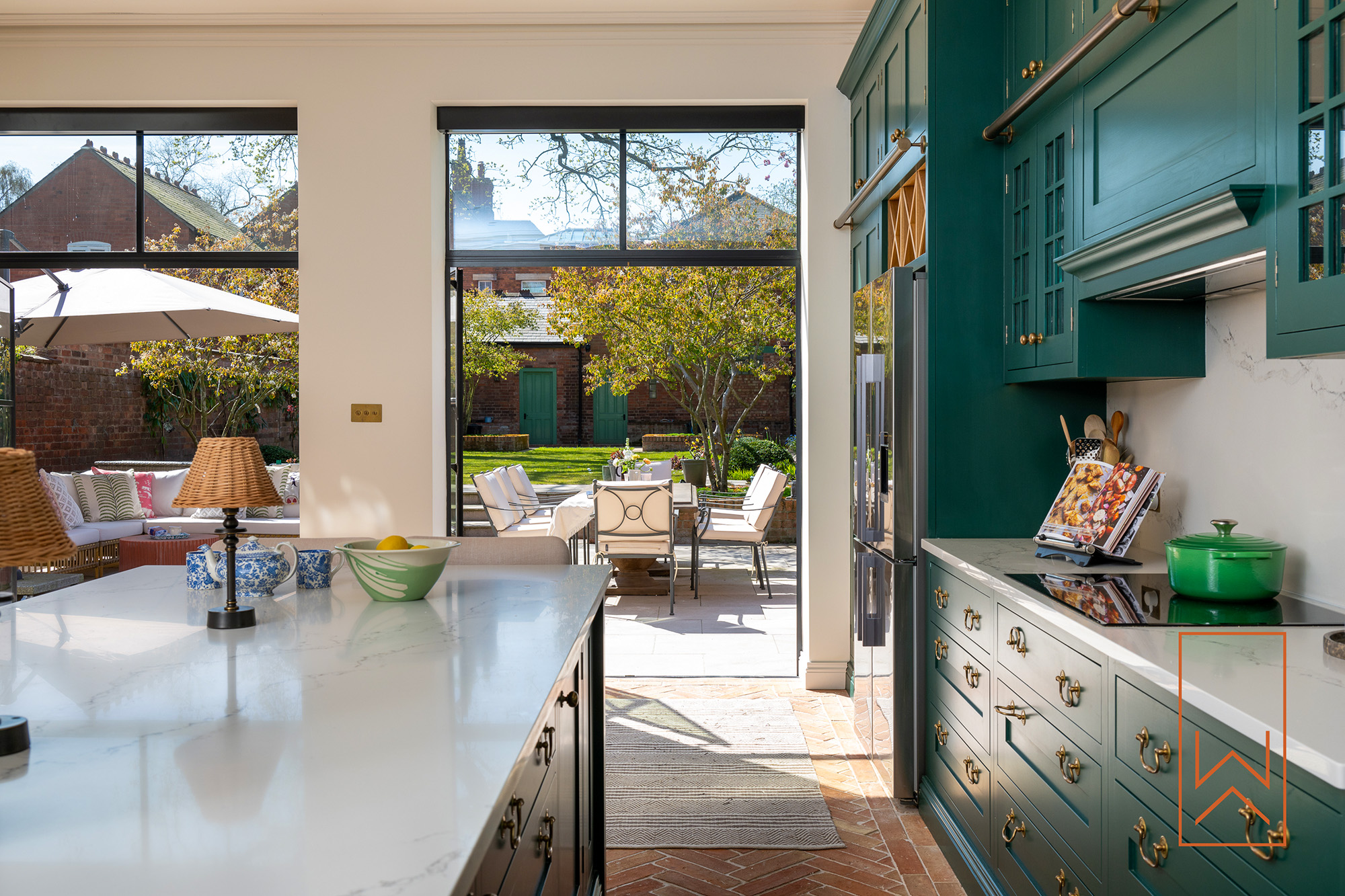 Kitchen garden extension opening onto landscaped terrace in Leamington Spa town garden.