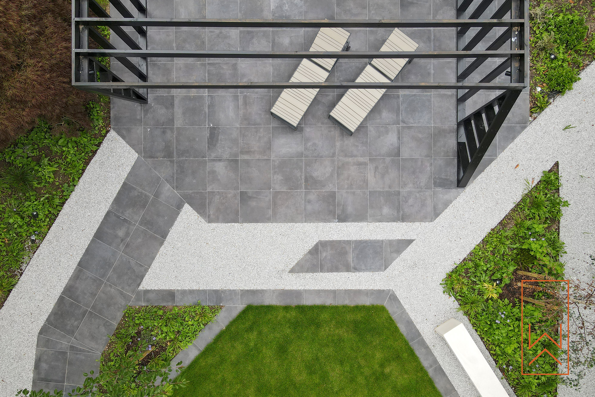 Geometric garden layout with porcelain paving and gravel paths in modern garden.