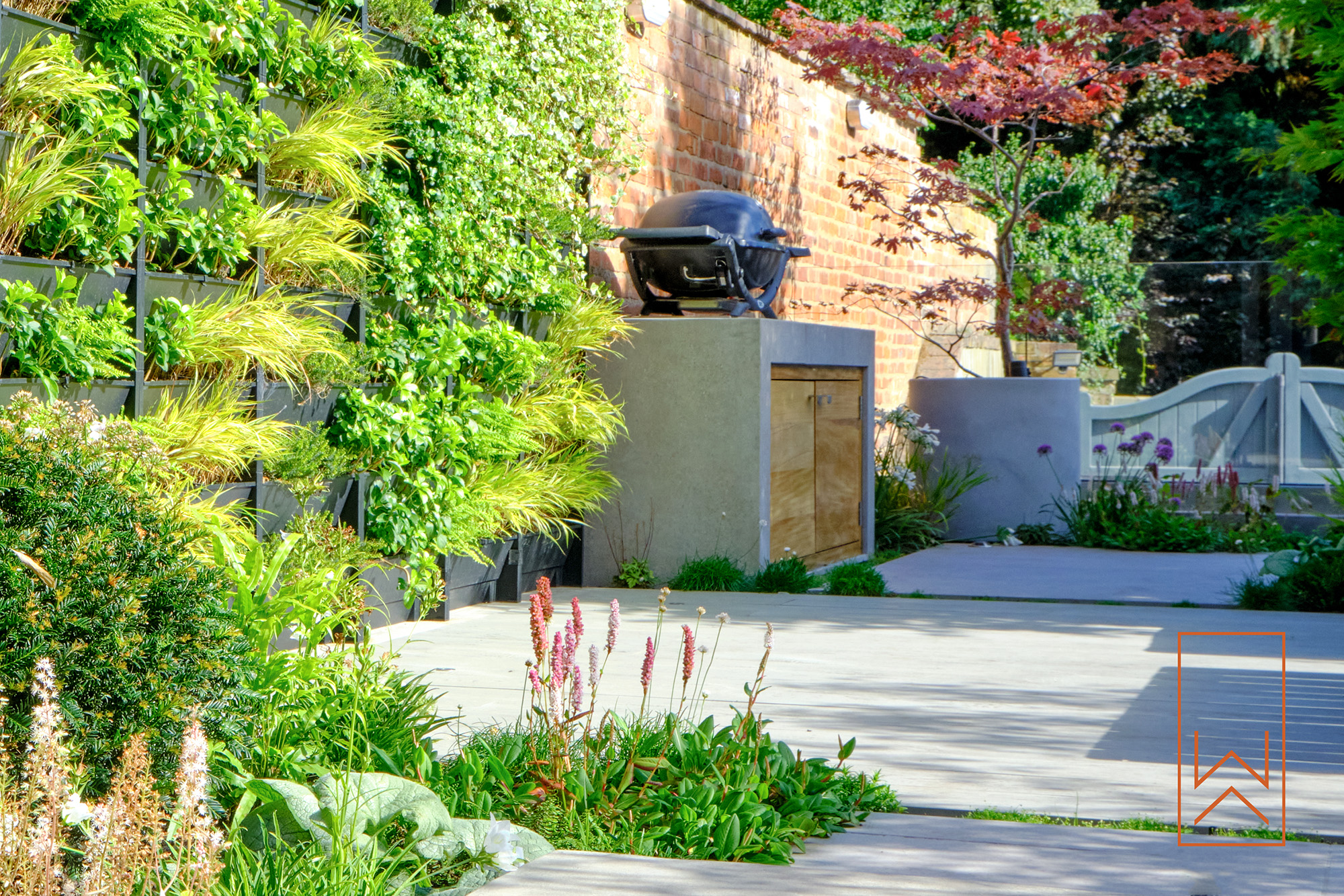 Living wall and outdoor sofa in contemporary Warwick courtyard garden.